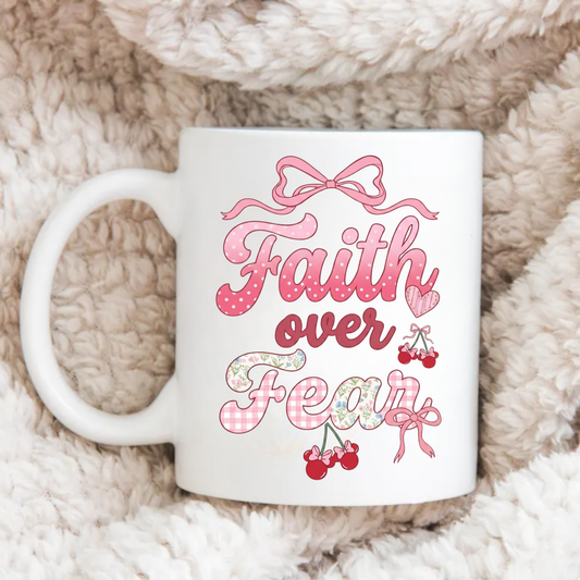 White mug with 'Faith over Fear' design on a fluffy beige surface
