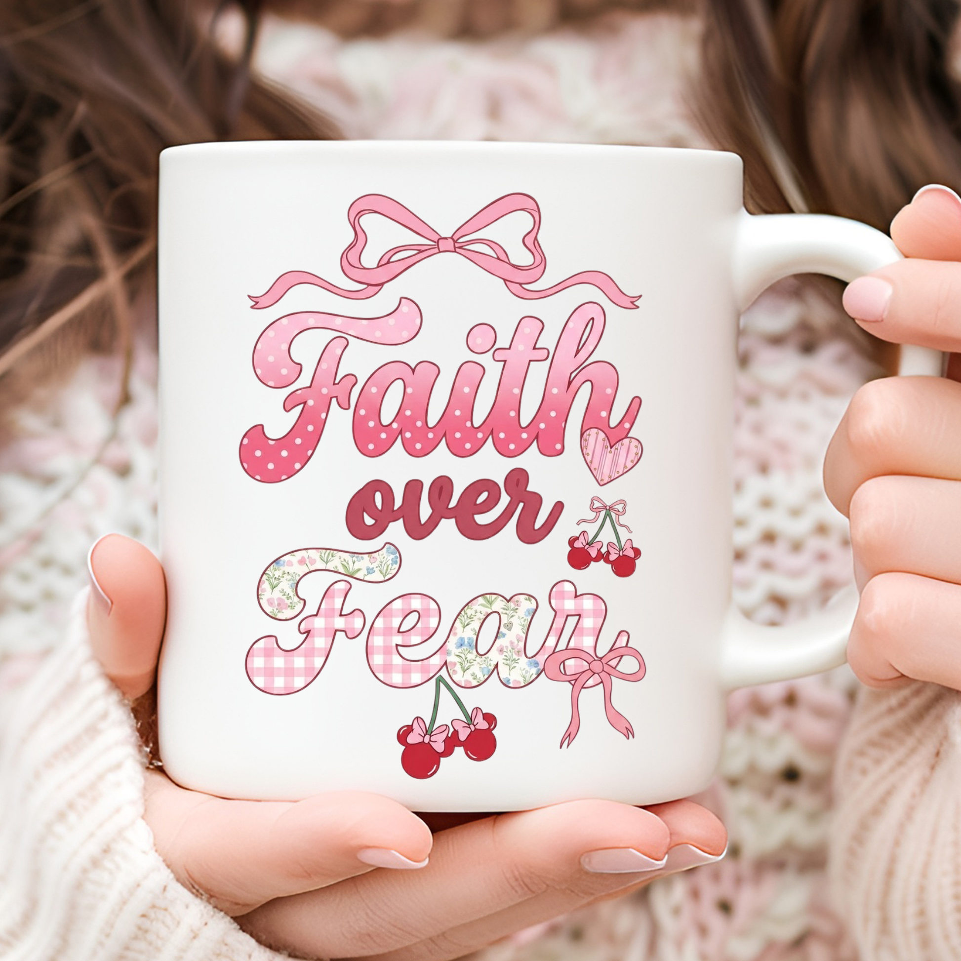 White mug with 'Faith over Fear' design held by a person