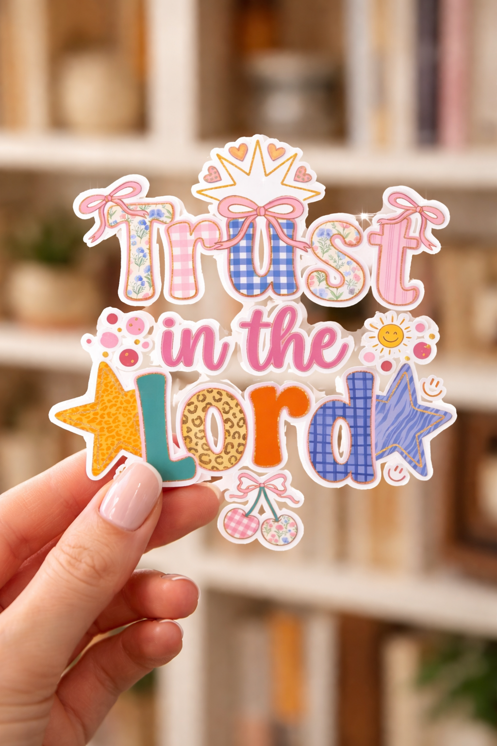 Colorful 'Trust in the Lord' sticker held by a hand with a blurred indoor background