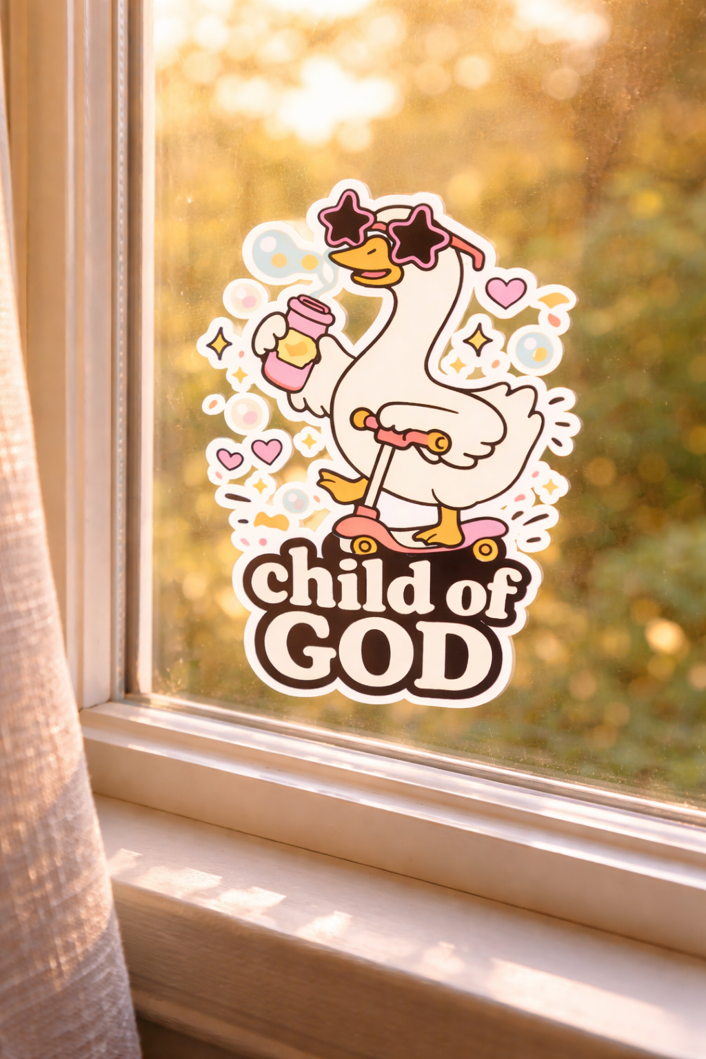 Sticker of a cartoon goose with 'child of God' text on a window
