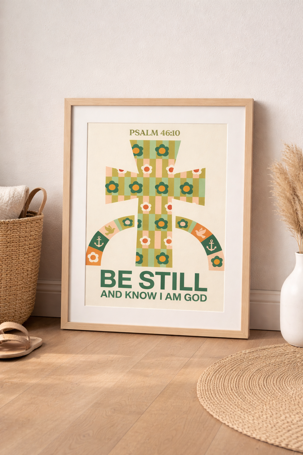 Magazine-style home decor image featuring a framed religious poster with colorful cross motif and Psalm 46:10 verse in soft daylight.