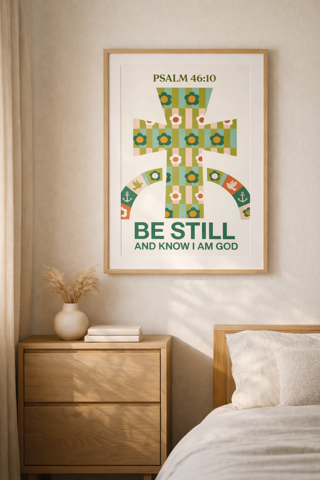 Warm natural lighting illuminates a framed “Be Still and Know I Am God” poster in a clean Scandinavian-inspired room setting.