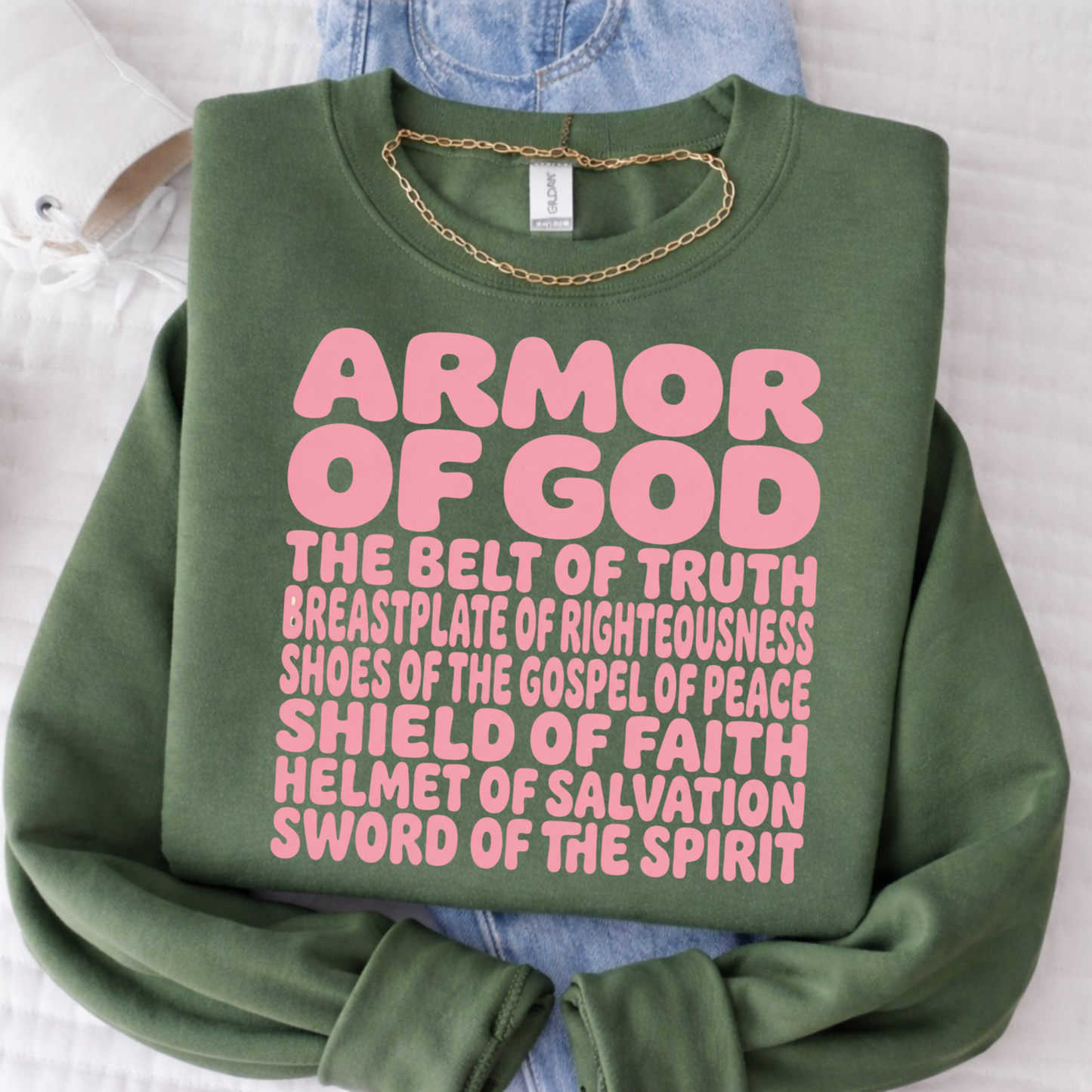 Green sweatshirt with pink 'Armor of God' text on a white background