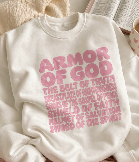Person wearing a white sweatshirt with 'Armor of God' text on a white background