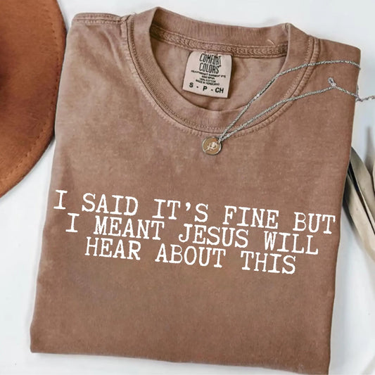 Brown t-shirt with humorous text "I said it's fine but I meant Jesus will hear about this" on a white background