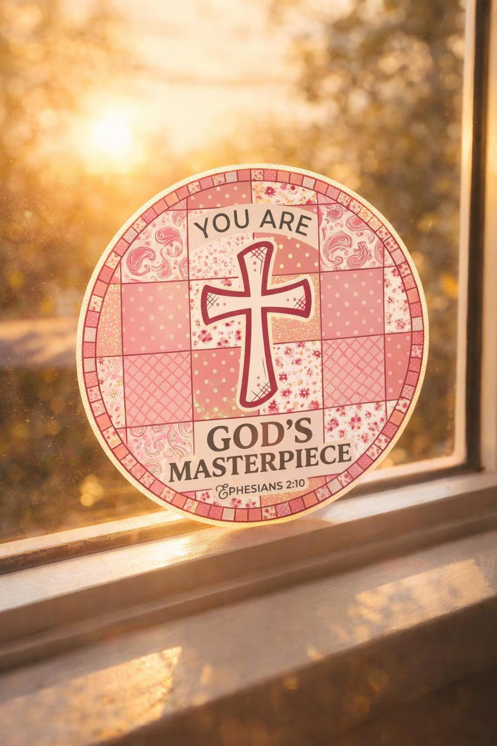 Decorative sticker "You Are God's Masterpiece" with cross design and text on a window
